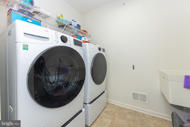 washroom with independent washer and dryer