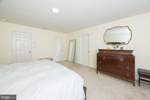 bedroom featuring light colored carpet