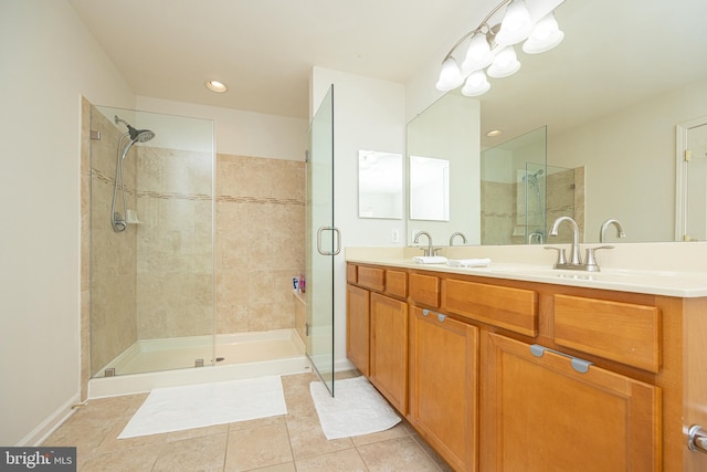 bathroom featuring vanity, a shower with shower door, and tile patterned flooring