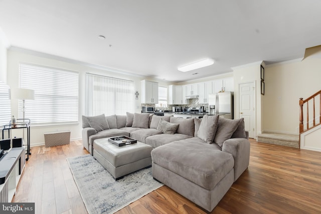 living room featuring crown molding and light wood-type flooring