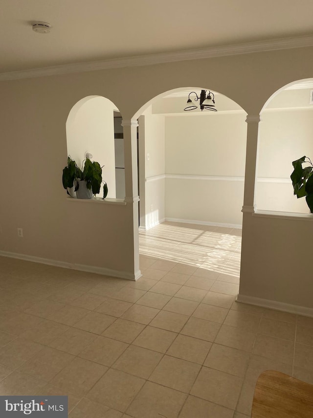 interior space featuring tile patterned floors and crown molding