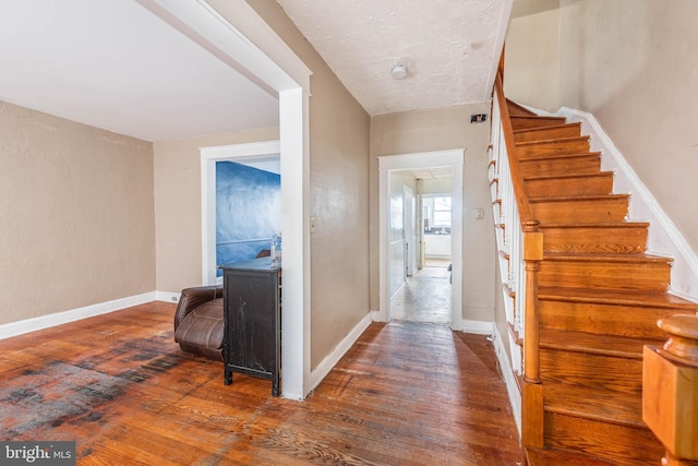 interior space with wood-type flooring and a textured ceiling