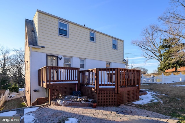 rear view of property with a wooden deck