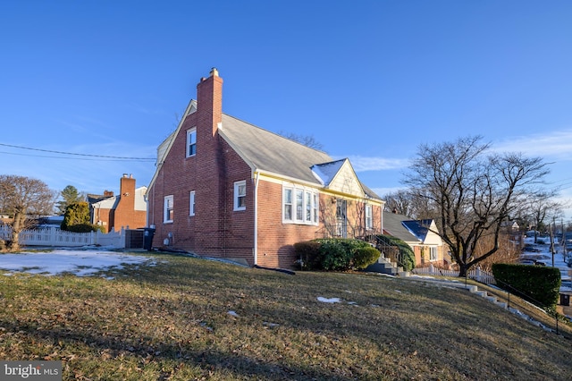 view of property exterior with a lawn