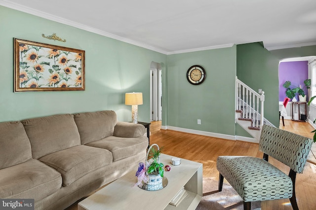 living room with ornamental molding and light wood-type flooring