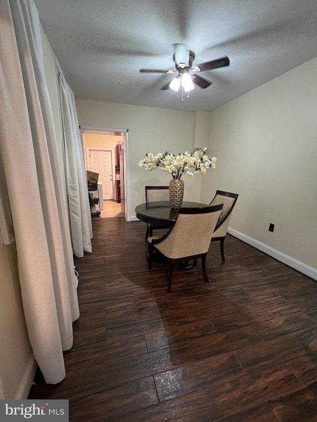 dining area featuring a textured ceiling and dark hardwood / wood-style floors