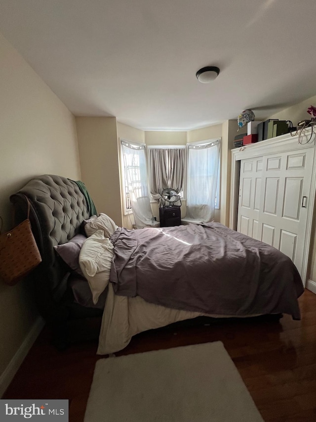 bedroom featuring a closet and dark hardwood / wood-style flooring