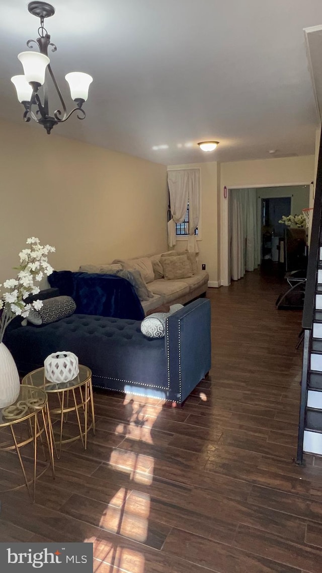 living room featuring dark hardwood / wood-style floors and a notable chandelier