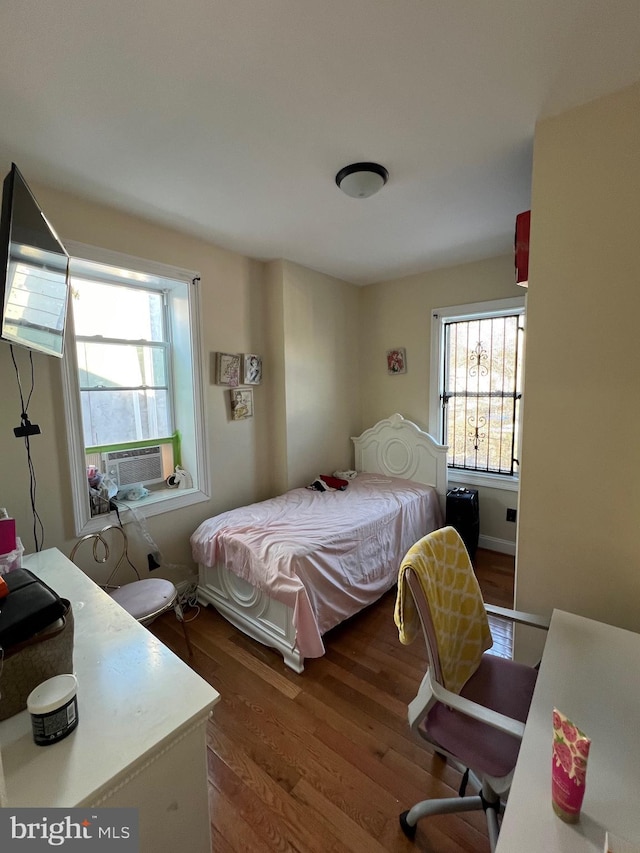 bedroom with wood-type flooring and cooling unit