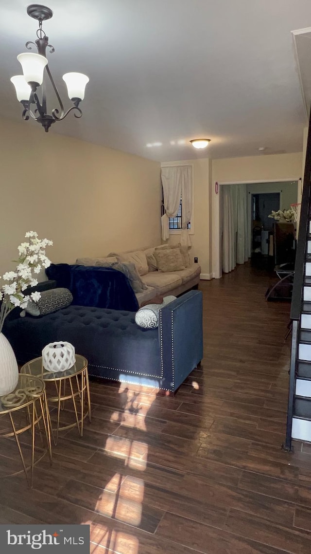 living room with a chandelier and dark hardwood / wood-style floors