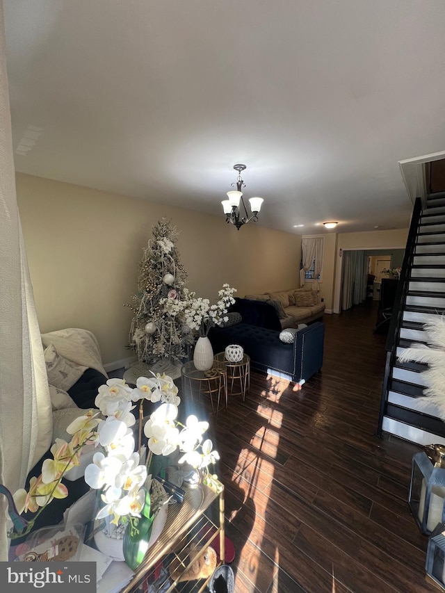 living room featuring a notable chandelier and dark hardwood / wood-style flooring