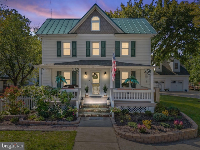 view of front facade with a porch and a garage