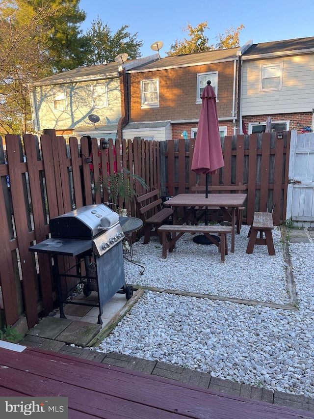 wooden deck with a grill