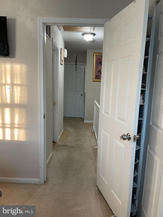 hallway with light colored carpet