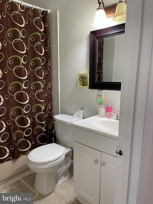 full bathroom with shower / bath combo with shower curtain, tile patterned floors, vanity, and toilet