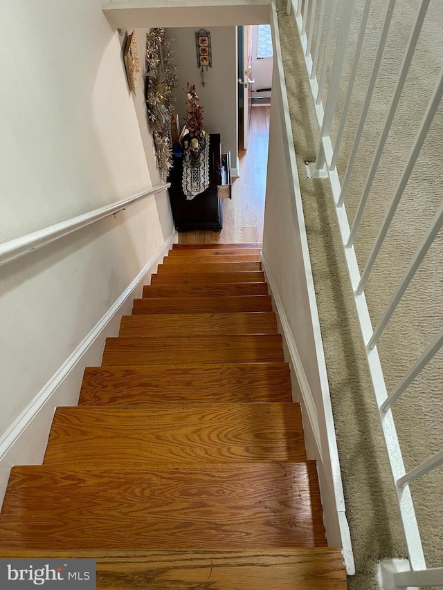 stairway with hardwood / wood-style floors