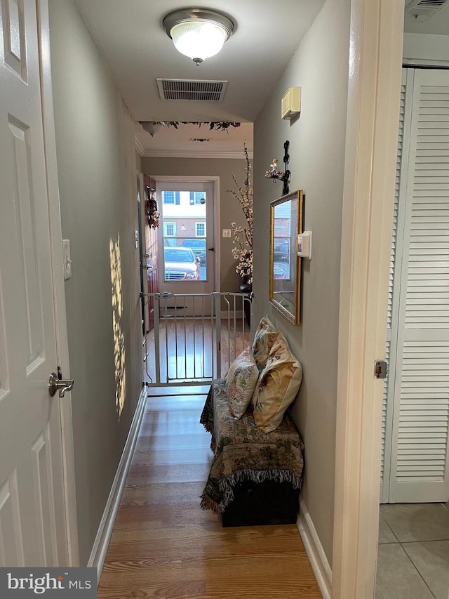 hallway with hardwood / wood-style floors