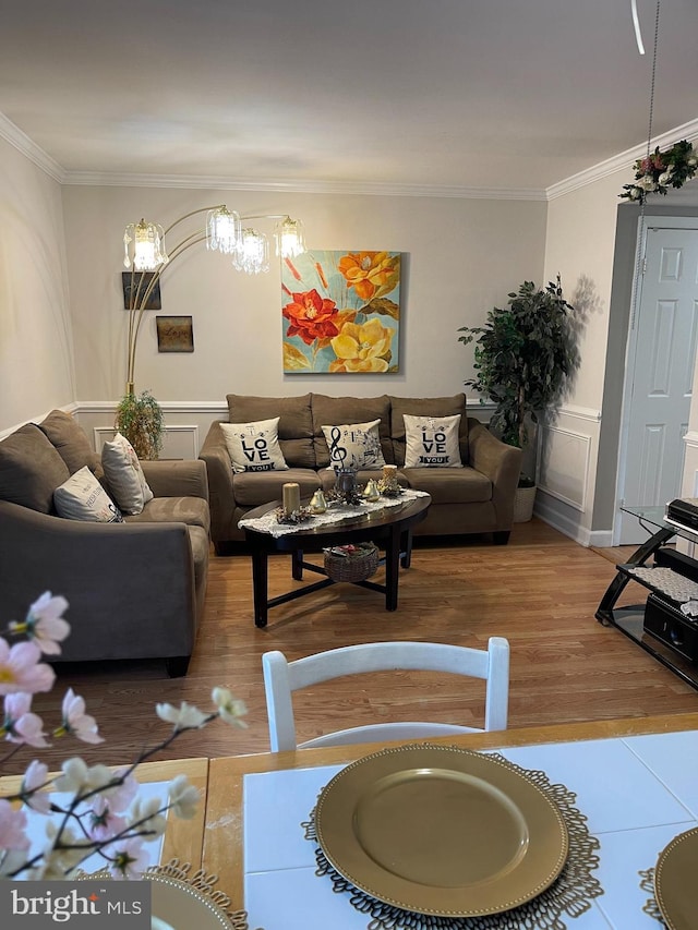 living room featuring wood-type flooring and crown molding