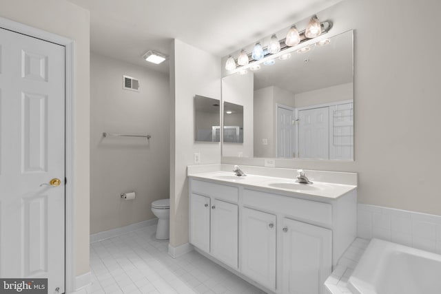 bathroom featuring toilet, double vanity, a sink, and visible vents