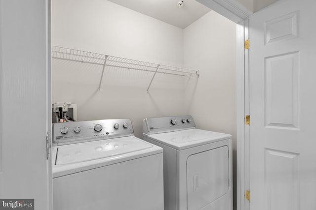 washroom with laundry area and washer and dryer