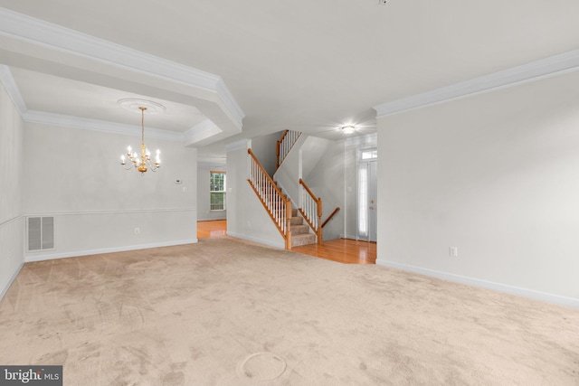 carpeted spare room featuring visible vents, crown molding, a notable chandelier, and stairs