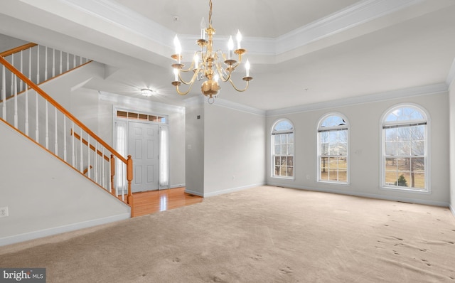 unfurnished living room featuring carpet, stairs, baseboards, and crown molding