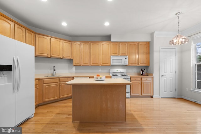 kitchen with white appliances, light wood-style flooring, light countertops, and a sink