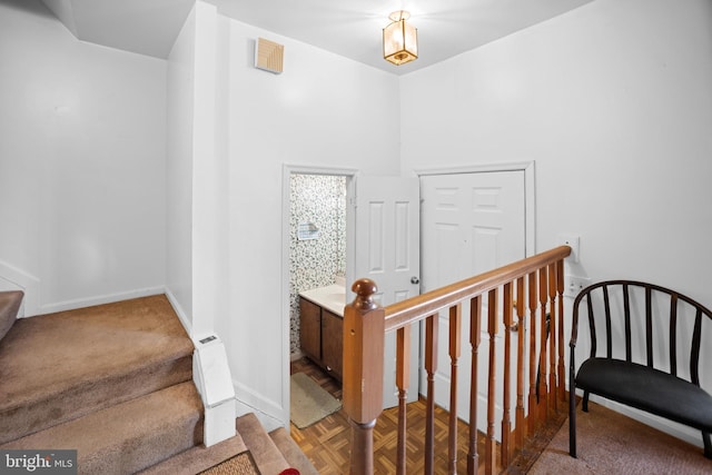 stairway with parquet flooring