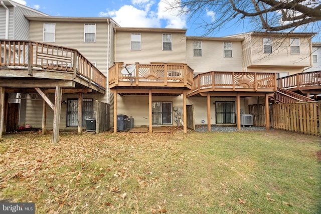 back of property featuring a wooden deck, a yard, and central AC unit