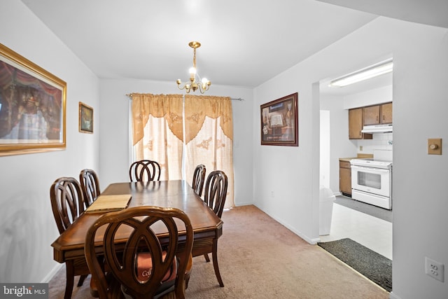 carpeted dining space with an inviting chandelier