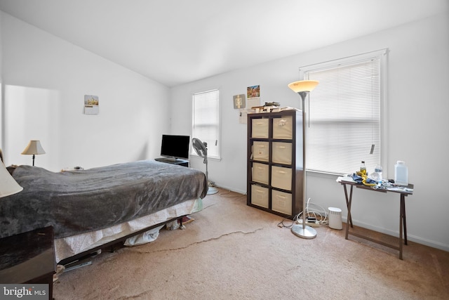 bedroom featuring vaulted ceiling and carpet