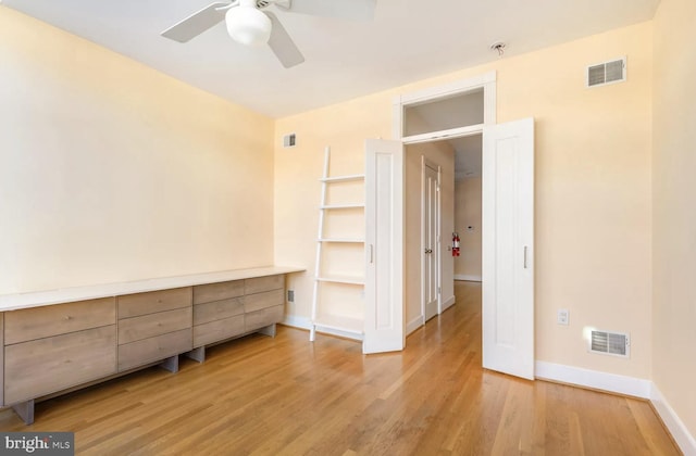 unfurnished bedroom with light wood-type flooring and visible vents