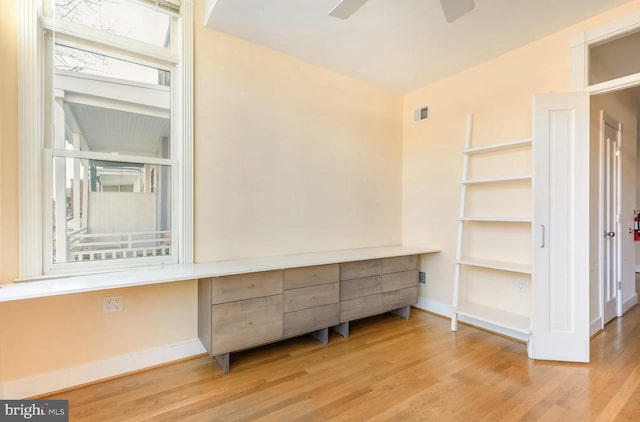 interior space featuring visible vents, baseboards, and wood finished floors