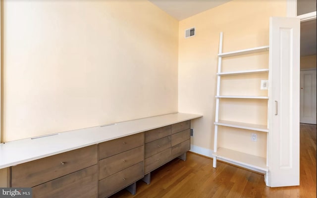 spacious closet featuring visible vents and wood finished floors