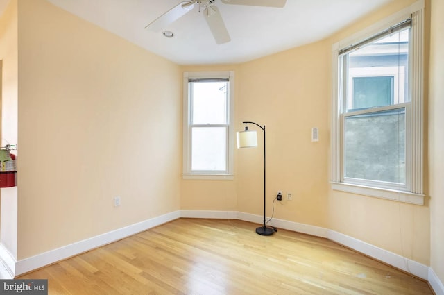 spare room featuring light hardwood / wood-style floors, plenty of natural light, and ceiling fan