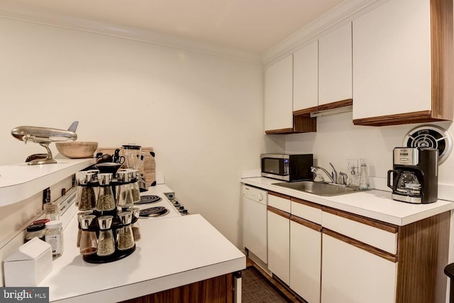 kitchen with light countertops, stainless steel microwave, a sink, and white cabinetry