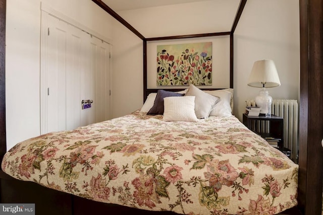 bedroom featuring a closet and radiator heating unit