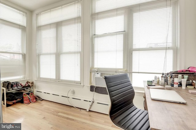 home office featuring light wood-type flooring and a baseboard radiator