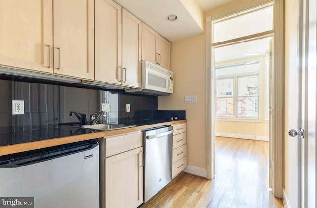 kitchen with white microwave, tile counters, decorative backsplash, and dishwasher