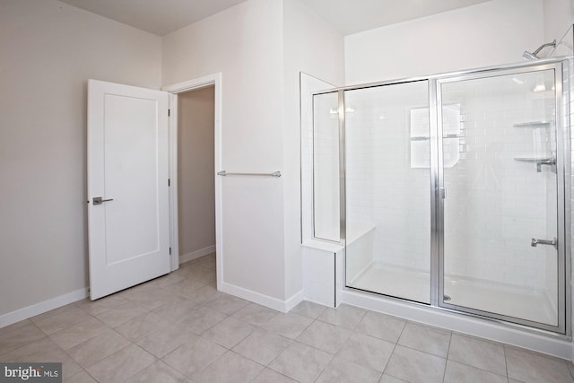 bathroom featuring a shower with door and tile patterned flooring