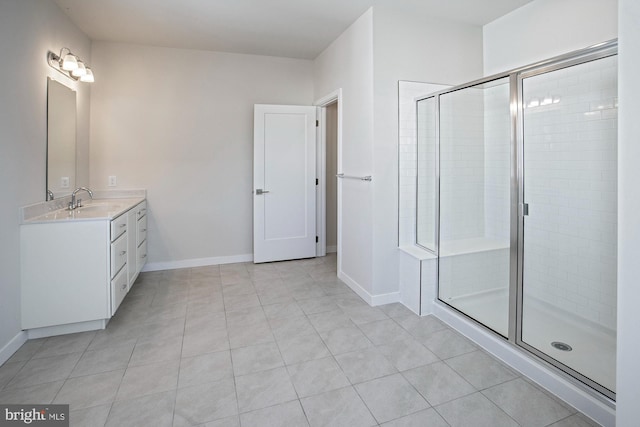 bathroom with an enclosed shower, vanity, and tile patterned floors