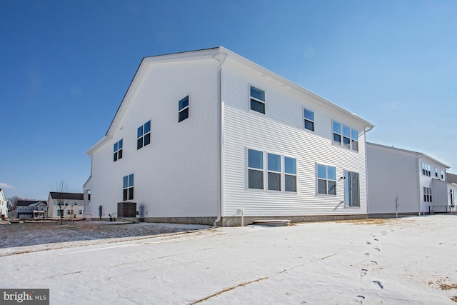 rear view of property with central AC