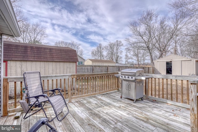 wooden deck with area for grilling and a storage shed