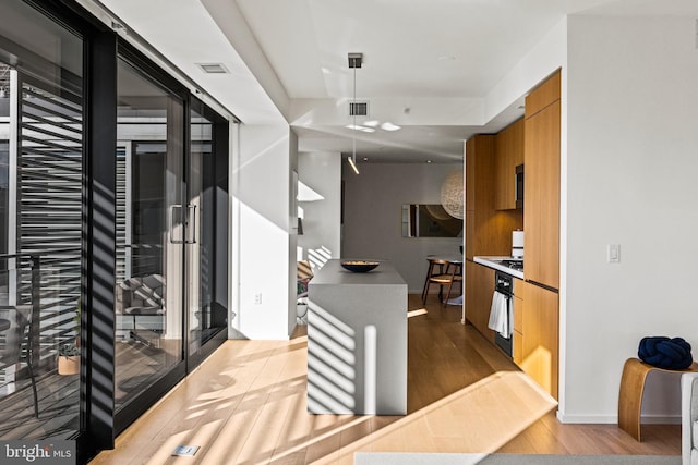 kitchen featuring wall oven and light hardwood / wood-style floors