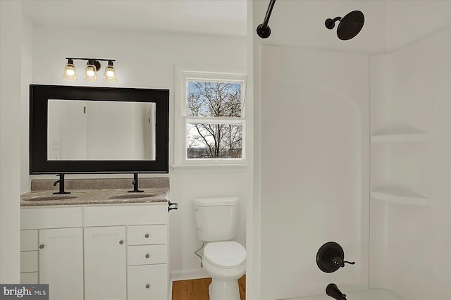 full bathroom featuring vanity, toilet, shower / bath combination, and hardwood / wood-style floors