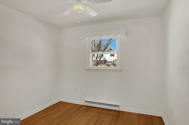 unfurnished room featuring hardwood / wood-style floors, ceiling fan, and baseboard heating