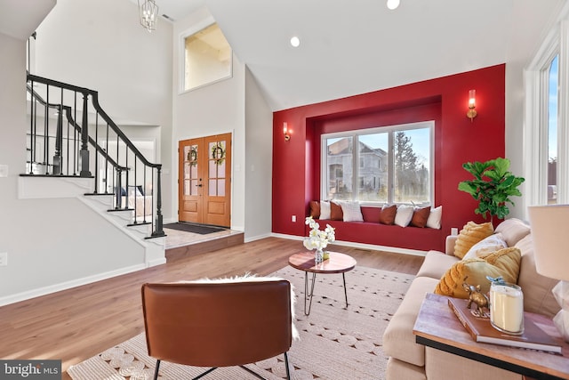 living room with high vaulted ceiling and wood-type flooring