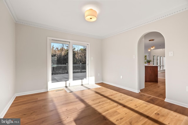 unfurnished room featuring hardwood / wood-style flooring and ornamental molding