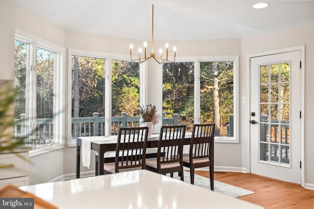 sunroom featuring an inviting chandelier and plenty of natural light