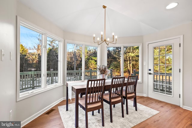 sunroom / solarium featuring a chandelier and a healthy amount of sunlight